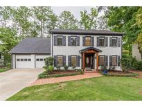 Charming two-story home with painted brick, black shutters, and a well-manicured lawn at 2911 Bentwood Dr, Marietta, GA 30062