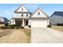 Charming two-story home features a well-manicured front yard, a two-car garage, and classic architectural details at 362 Reserve Overlook, Canton, GA 30115