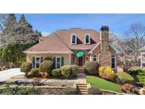 Charming two-story home with landscaped yard, stone accents, and a well-manicured lawn at 540 Clubfield Drive, Roswell, GA 30075