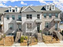 Townhome exterior showcasing brick facade, covered entryways, and landscaped front yards on a sunny day at 4000 Bethelview Ln, Suwanee, GA 30024