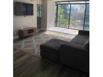 Bright living room with large windows, modern flooring, and stylish rug at 330 9Th Ne St # 11, Atlanta, GA 30309