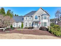 Charming two-story home featuring a well-manicured lawn and traditional architectural details at 4569 Chatsworth Overlook Ne, Roswell, GA 30075