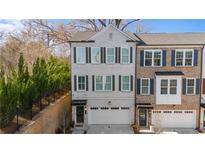 Beautiful new construction townhome featuring painted brick, three stories, and an attached two car garage at 174 Sidney St, Marietta, GA 30060