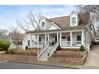 Charming two-story home with a welcoming front porch and well-manicured landscaping at 116 Holland Nw St, Marietta, GA 30064