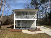 Charming two-story home featuring a front-facing porch and mature landscaping at 251 Margaret St, Fairburn, GA 30213