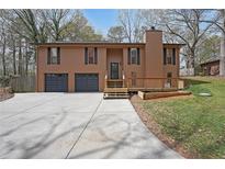 Charming home featuring a two-car garage, a cozy deck, and a well-maintained front yard at 1072 Powell Wright Rd, Marietta, GA 30066