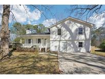 Charming two-story home with a covered front porch and well-maintained lawn and driveway at 55 Sunset Rd, Mcdonough, GA 30253