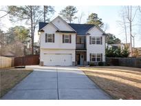 Charming two-story home featuring a two-car garage, white siding, and contrasting shutters at 793 Round Tree Ct, Lawrenceville, GA 30045