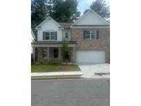Charming two-story home with a brick facade, a two-car garage, and a well-manicured front lawn at 793 River Gardens Dr, Atlanta, GA 30354