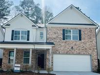 Charming two-story home with a brick facade, white accents and a two car garage at 793 River Gardens Dr, Atlanta, GA 30354