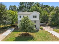 Two-story home with a well-maintained lawn and mature trees at 1583 Columbia Cir, Decatur, GA 30032
