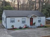 Charming single-story home with a welcoming red front door and cozy front yard decor at 2077 Brockett Rd, Tucker, GA 30084