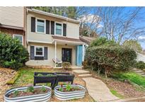 Charming two-story home featuring a manicured lawn and inviting front porch at 544 Stratford Grn, Avondale Estates, GA 30002