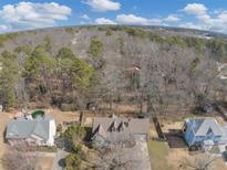 A captivating aerial view of the property nestled amongst a lush forest setting at 742 Wilkes Dr, Loganville, GA 30052
