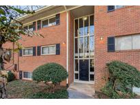 Charming brick building with black shutters, complemented by neat landscaping at 1111 Clairemont Ave # P5, Decatur, GA 30030