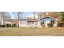 Charming single-story home featuring a welcoming front porch and a convenient covered carport at 1729 Norden Rd, Riverdale, GA 30296