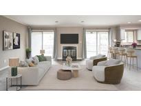 Bright living room featuring a fireplace, sliding doors to a balcony, and an open layout to the kitchen at 14 Muncy Se Ct, Smyrna, GA 30080