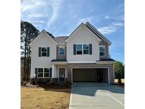 Two-story home with light siding, dark shutters, brick accents, and an attached two-car garage at 1462 Stephens View Dr, Loganville, GA 30052