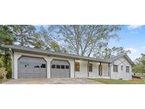 Charming single-story home featuring a two-car garage, gray trim, and a well-maintained front yard at 4647 Wonder Valley Trl, Decatur, GA 30034