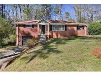 Charming single-story brick home with well-maintained front yard and driveway at 793 Parkway Se Dr, Smyrna, GA 30080