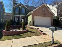 Charming two-story home with manicured landscaping and a brick-accented facade at 3513 Kensington Parc Cir, Avondale Estates, GA 30002