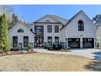 Stunning two-story white brick home boasts elegant black trim and a well-manicured lawn at 1046 Sterling Ridge, Marietta, GA 30062