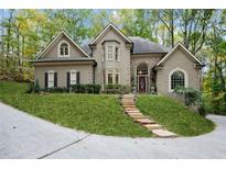 Stunning home with stone accents, arched windows, and a beautiful lawn and stairway entrance at 5004 Barnwood Nw Ter, Kennesaw, GA 30152