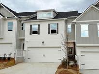 Charming townhome featuring a two-car garage, neutral color palette, and well-maintained landscaping at 1297 Fern Ridge Ct # 24, Norcross, GA 30093
