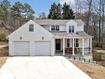 Charming two-story home with a welcoming front porch and a two-car garage, landscaped with shrubbery at 2826 Cobb Place Manor Ct, Marietta, GA 30066