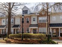 Charming townhomes featuring varied exteriors of brick, stone, and siding, creating a unique streetscape at 1175 Glenridge Pl, Atlanta, GA 30342