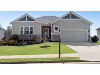 Charming one-story home with stone accents, well-manicured lawn and two-car garage at 3730 Townley Ln, Cumming, GA 30040