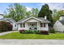 Charming craftsman home with a landscaped yard, a welcoming porch, and a light blue front door at 6 Arc Ne Way, Atlanta, GA 30305