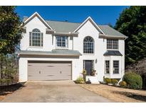 Charming two-story home with a manicured lawn and attached two-car garage at 7880 Brands Hatch Blvd, Cumming, GA 30040