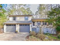 Charming two-story home featuring a spacious two-car garage and a welcoming front porch at 3702 Cambridge Sw Dr, Marietta, GA 30064