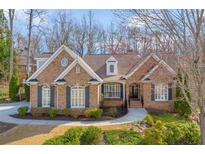 Charming brick home featuring manicured landscaping, symmetrical design, and welcoming front entry at 800 E Shore Dr, Canton, GA 30114