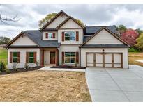 Charming two-story home featuring a brick facade, wood accents, and a spacious two-car garage at 3132 Rosebud Rd, Loganville, GA 30052