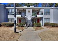 Attractive condo complex featuring neat landscaping, symmetrical stairs, and neutral paint at 586 Windchase Ln, Stone Mountain, GA 30083