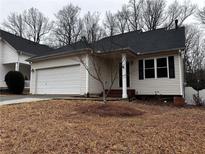 Charming single-story home featuring vinyl siding, an attached garage, and a well-maintained front yard in a quiet neighborhood at 3231 Liberty Commons Nw Dr, Kennesaw, GA 30144