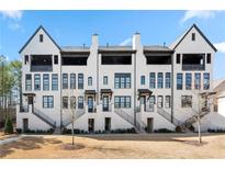 Charming new construction townhomes feature brick exteriors, private balconies, and landscaped front yards at 714 Opera Ln, Alpharetta, GA 30009