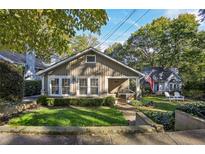 Charming bungalow with a manicured lawn and inviting front porch at 1111 Seaboard Nw Ave, Atlanta, GA 30318