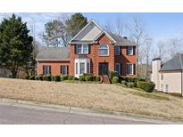 Charming two-story brick home with black shutters and manicured landscaping at 231 Beechwood Ln, Stone Mountain, GA 30087