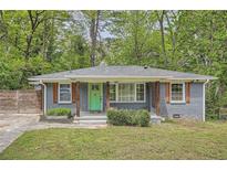 Charming grey brick home with a bright green front door and wood column accents at 2797 Gresham Se Rd, Atlanta, GA 30316