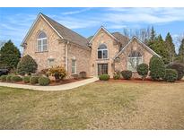 Charming brick home featuring manicured landscaping, arched windows, and a welcoming front entrance at 1132 Venetian Ln, Hampton, GA 30228