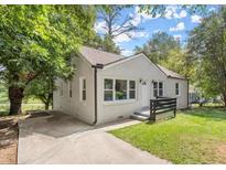 Charming single Gathering home with a well maintained lawn and a large driveway at 316 Henry Aaron Ave, Atlanta, GA 30310