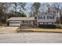 Charming two-story home featuring a well-maintained front yard with established landscaping at 2690 Manassas Pl, Snellville, GA 30039