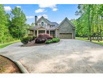 Charming craftsman home with a circular driveway and lush landscaping at 351 Allendale Dr, Canton, GA 30115
