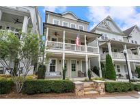 Charming two-story home with a welcoming porch and manicured landscaping, perfect for curb appeal at 375 Banbury Xing, Alpharetta, GA 30009