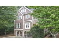 Charming two-story home with brown shingle and brick exterior and attached two-car garage at 2647 Brickell Sq, Atlanta, GA 30341