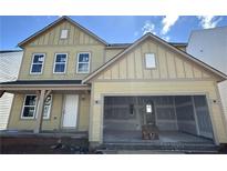 Two-story home featuring a large garage, inviting front porch, and craftsman-style details at 41 Okeechobee Way, Braselton, GA 30548