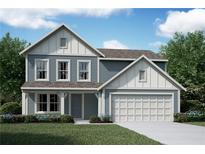 Charming two-story home with light blue siding, white trim, a two car garage, and a well-manicured lawn at 41 Okeechobee Way, Braselton, GA 30548